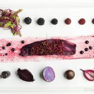 Śledź purpurowy z fioletowymi warzywami oraz jagodami, jeżynami i malinami  dodatkiem kiełków i listków buraka